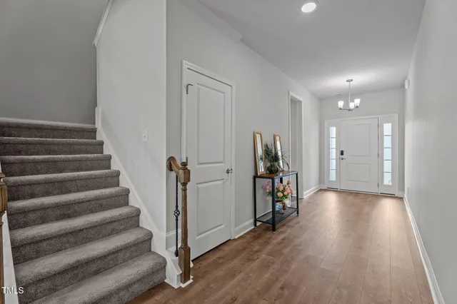 a view of an entryway with wooden floor and windows
