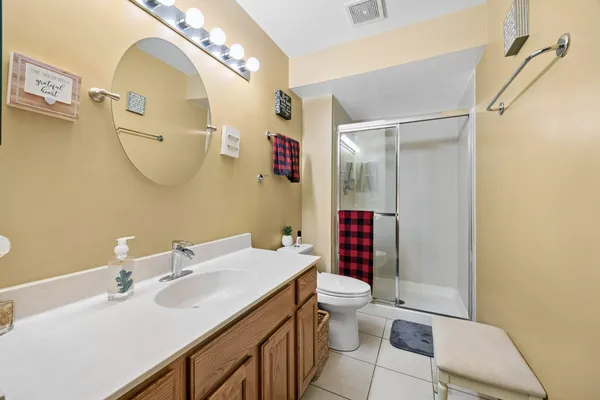 a bathroom with a sink mirror vanity and toilet