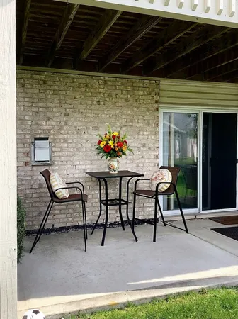 a patio with table and chairs