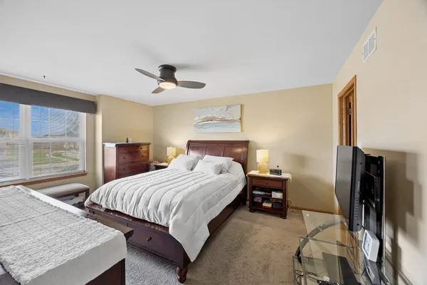 a bedroom with a bed and a chandelier