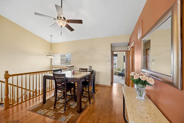 a view of a dining room and livingroom with furniture wooden floor a chandelier