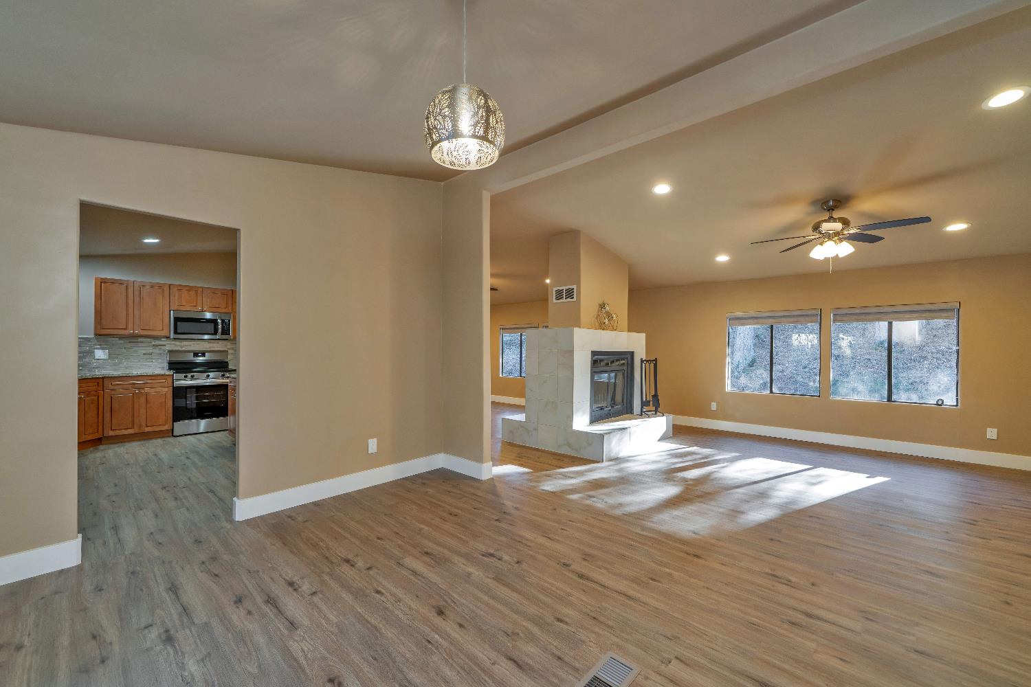 4420 Pleasant Valley Road, Unit 155 Diamond Springs, CA 95619 - Photo 10 of 42 a view of an empty room with wooden floor and a kitchen