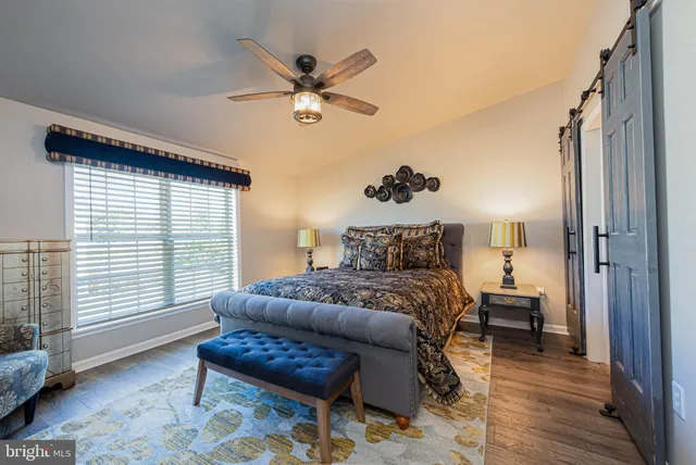 a spacious bedroom with a bed and a window