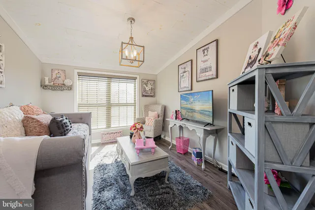 a living room with furniture gym equipment and a window