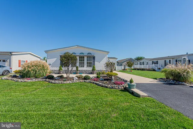 a view of a house with backyard porch and sitting area