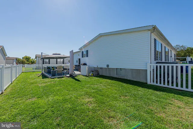 a view of a house with a yard and deck