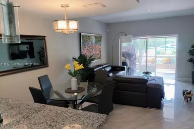 a kitchen with a dining table and chairs