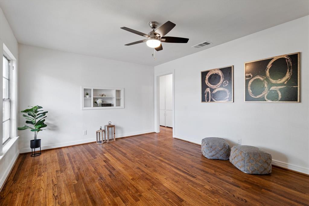 2411 Denison Street Denton, TX 76201 - Photo 5 of 15 a bedroom with a bed and a chandelier