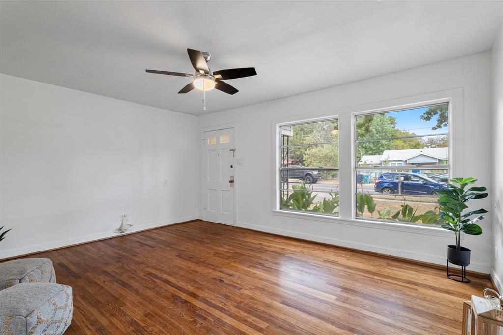 2411 Denison Street Denton, TX 76201 - Photo 6 of 15 a view of an empty room with wooden floor and a window