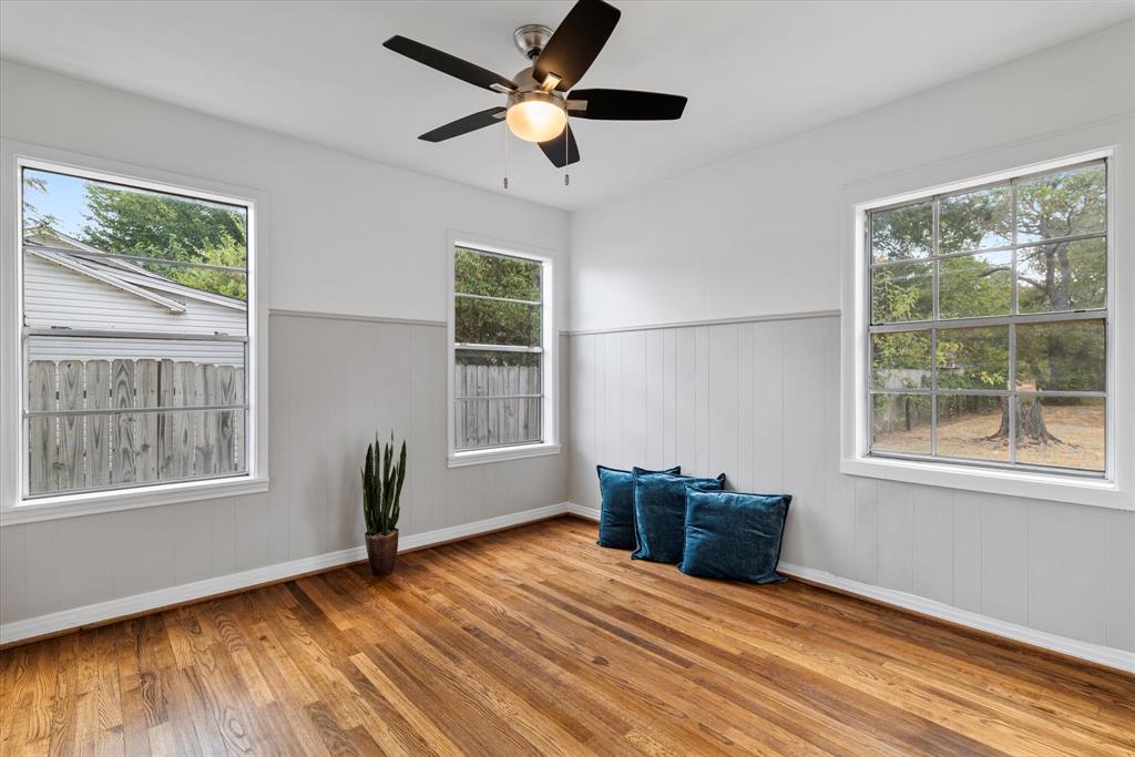 2411 Denison Street Denton, TX 76201 - Photo 8 of 15 a view of an empty room with a window and wooden floor