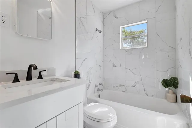 a bathroom with a sink a toilet and a bathtub