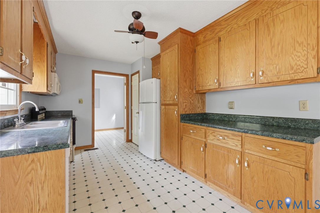 7208 Brandon Lane Prince George, VA 23875 - Photo 11 of 26 a kitchen with granite countertop a sink a stove and cabinets