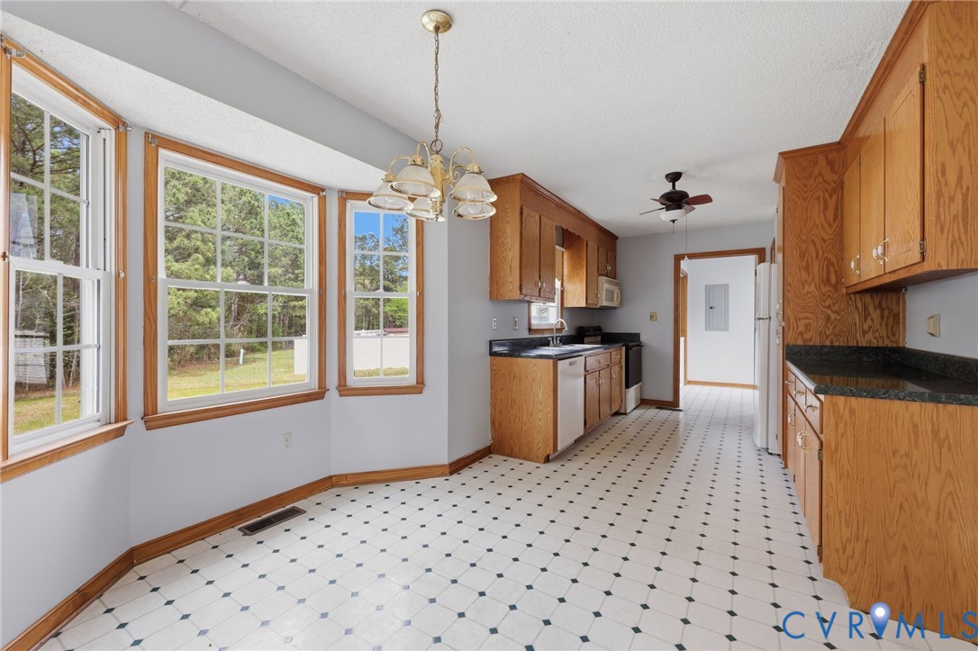 7208 Brandon Lane Prince George, VA 23875 - Photo 13 of 26 a kitchen with stainless steel appliances granite countertop a refrigerator a sink dishwasher a stove with white cabinets and wooden floor