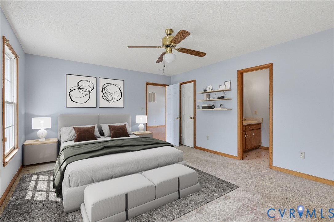 7208 Brandon Lane Prince George, VA 23875 - Photo 15 of 26 a bedroom with a bed and a chandelier