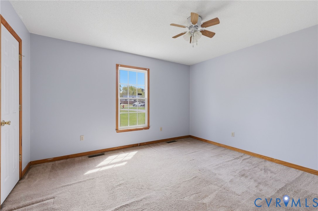 7208 Brandon Lane Prince George, VA 23875 - Photo 18 of 26 an empty room with a window and a ceiling fan