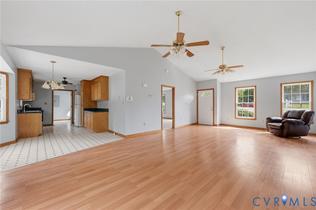 7208 Brandon Lane Prince George, VA 23875 - Photo 6 of 26 a view of a livingroom with furniture hardwood floor a ceiling fan and windows