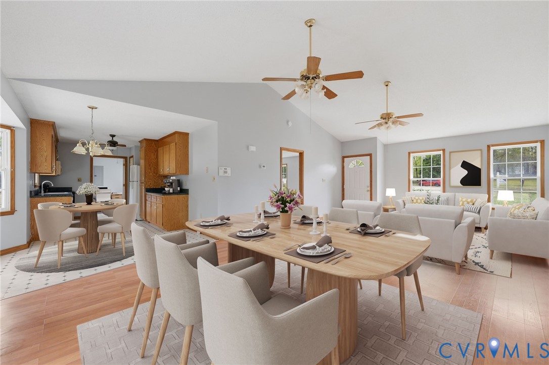 7208 Brandon Lane Prince George, VA 23875 - Photo 7 of 26 a view of a dining room and livingroom with furniture wooden floor a rug a painting and a chandelier