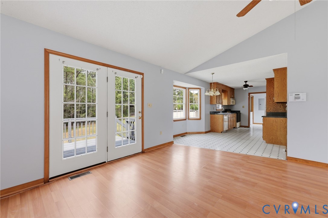 7208 Brandon Lane Prince George, VA 23875 - Photo 9 of 26 a view of a big room with wooden floor and a kitchen