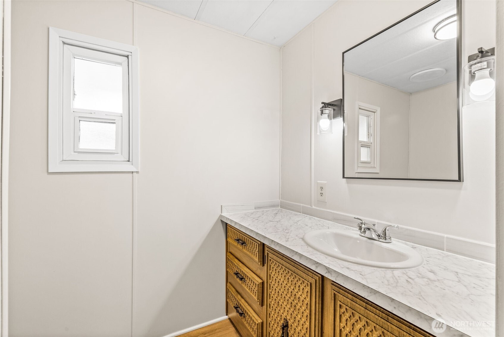 11330 East Riverside Drive, Unit 7 Bothell, WA 98011 - Photo 19 of 32 a bathroom with a granite countertop sink and a mirror