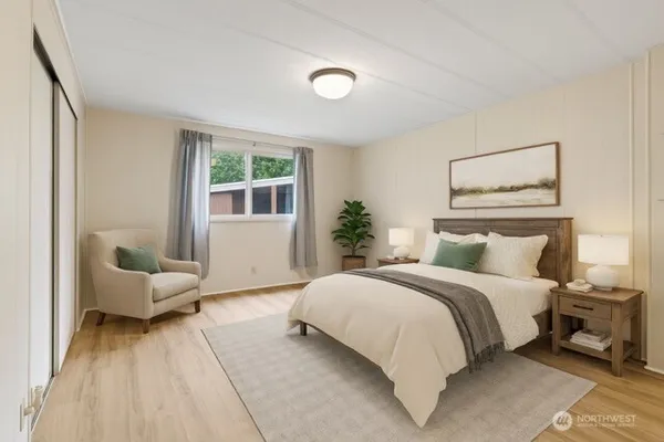 a bedroom with a large bed and a couch