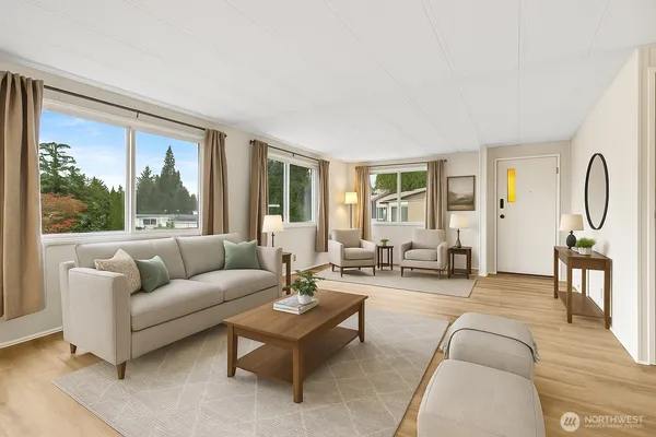 a living room with furniture and floor to ceiling windows