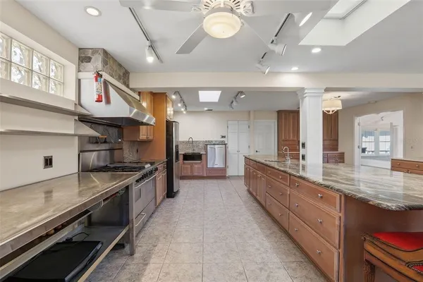 a large kitchen with stainless steel appliances and a large counter top oven