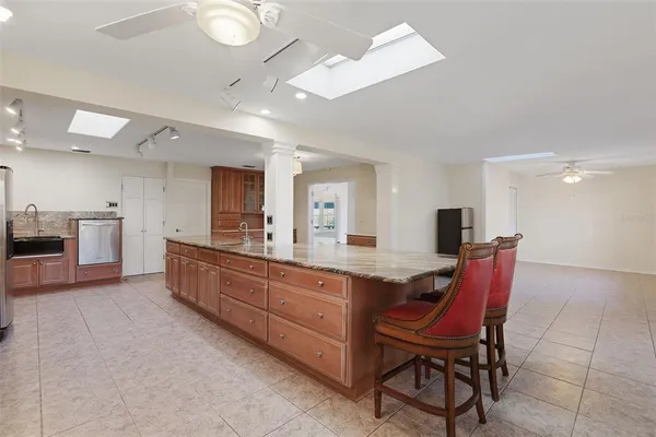 a large kitchen with a table and chairs in it