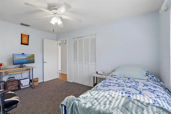 a bedroom with a bed and a chandelier