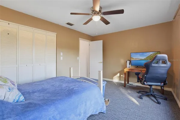 a bedroom with a chair and a desk