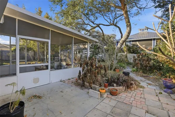 a backyard of a house with barbeque oven table and chairs