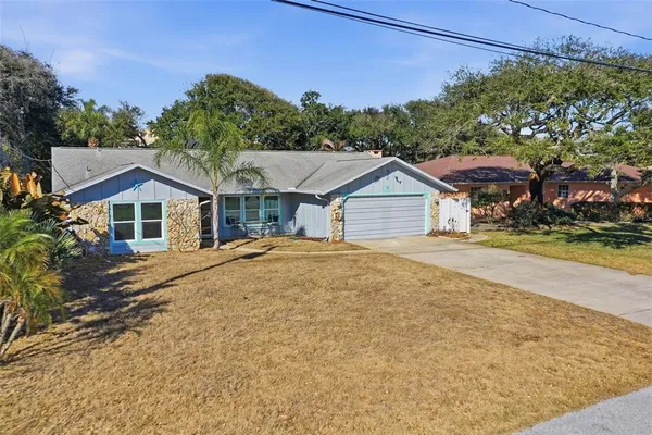 a aerial view of a house next to a yard