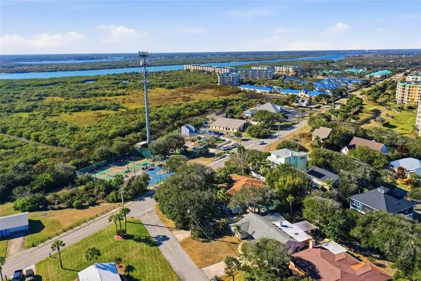 an aerial view of a house with a yard