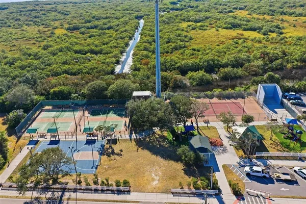 an aerial view of residential houses with outdoor space and street view