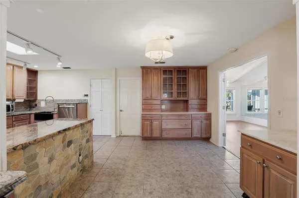 a large kitchen with kitchen island a sink stainless steel appliances and cabinets