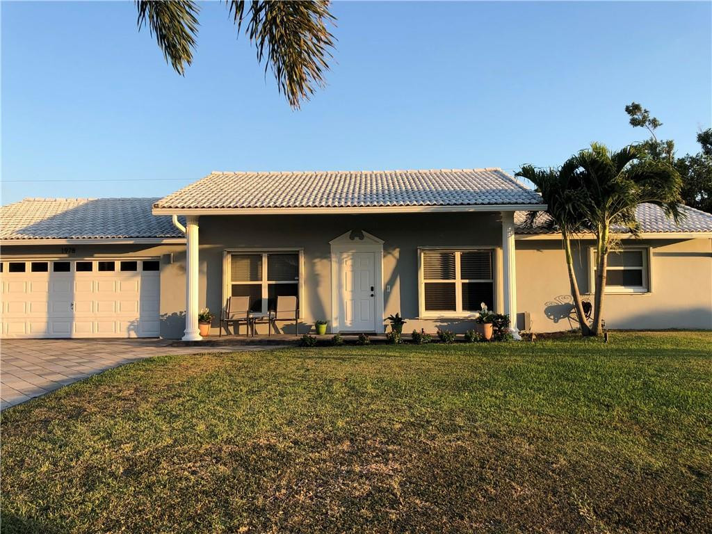 1978 Park Place Boca Raton, FL 33486 - Photo 1 of 34 a front view of a house with a garden