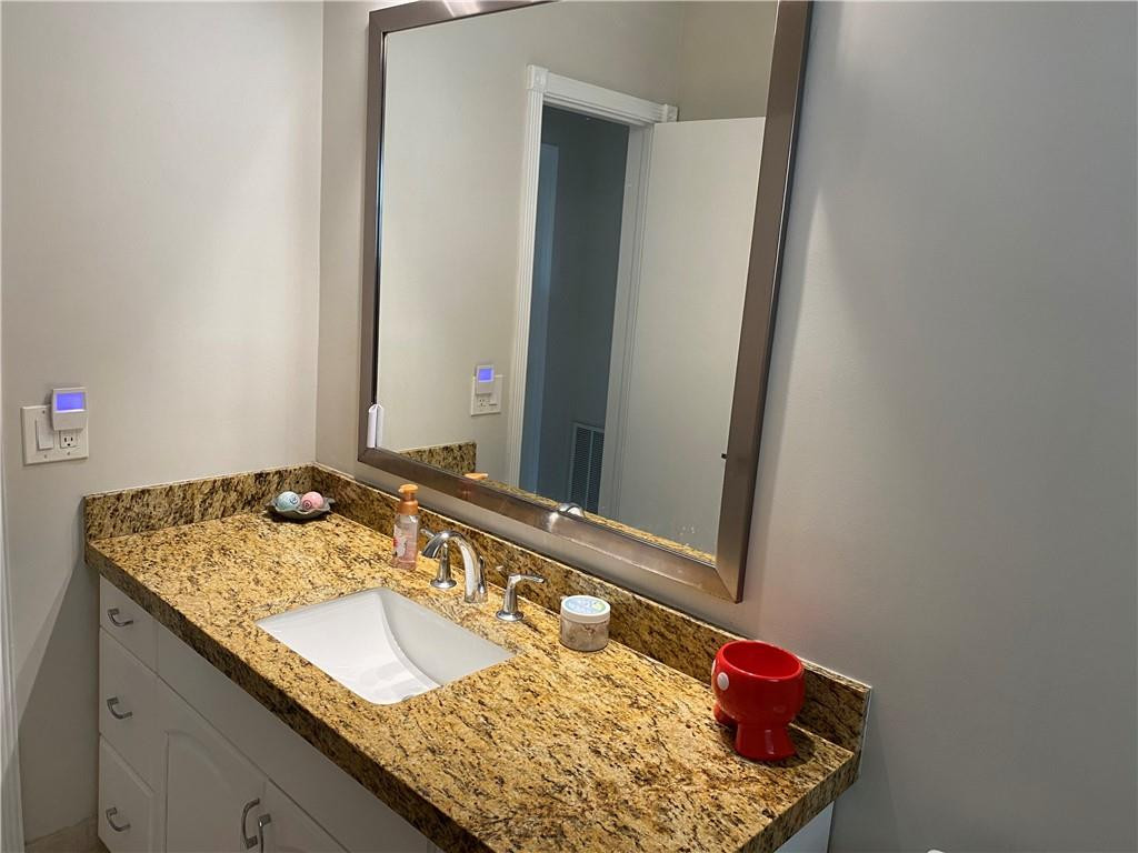 1978 Park Place Boca Raton, FL 33486 - Photo 11 of 34 a bathroom with a granite countertop sink and a mirror