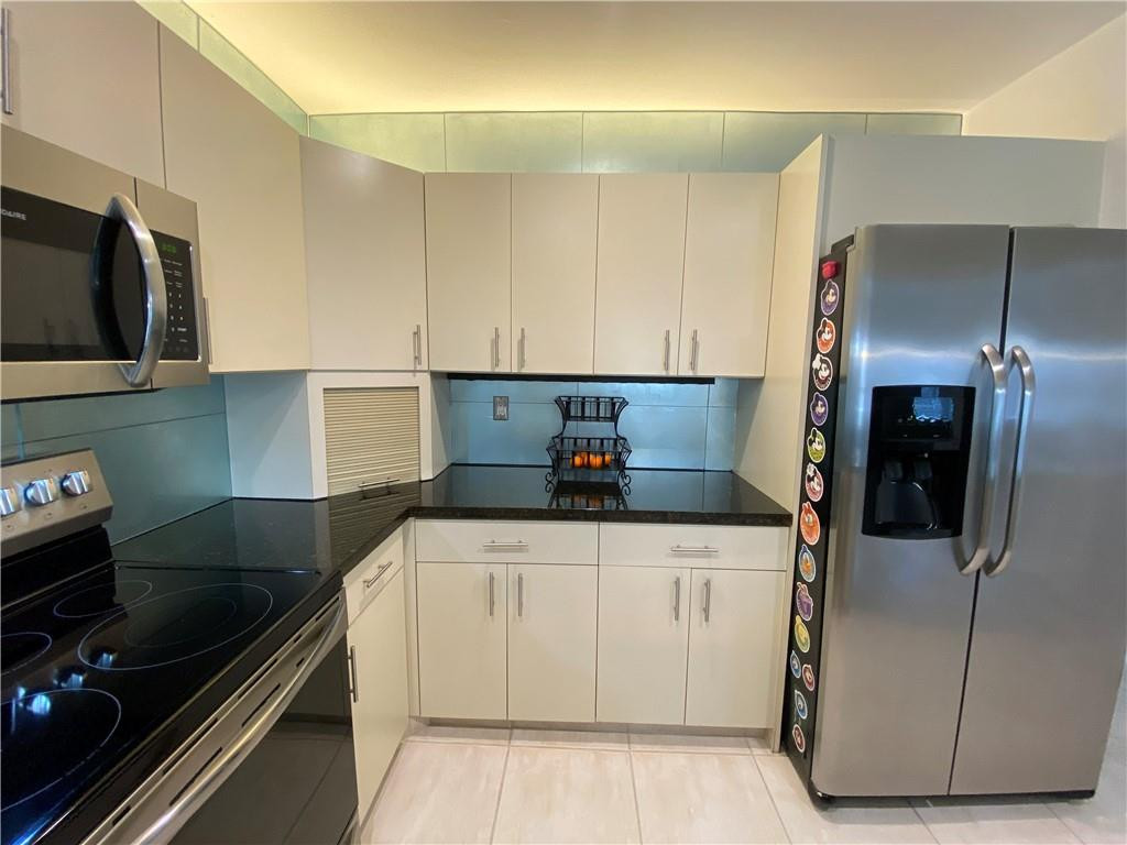1978 Park Place Boca Raton, FL 33486 - Photo 20 of 34 a kitchen with a sink a stove and refrigerator