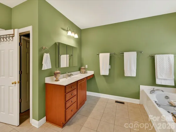 a bath tub sitting in a bathroom next to a window