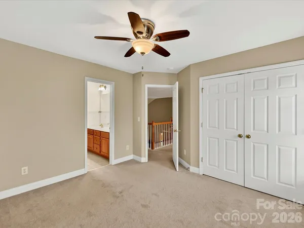 a view of an empty room with cabinet and a window