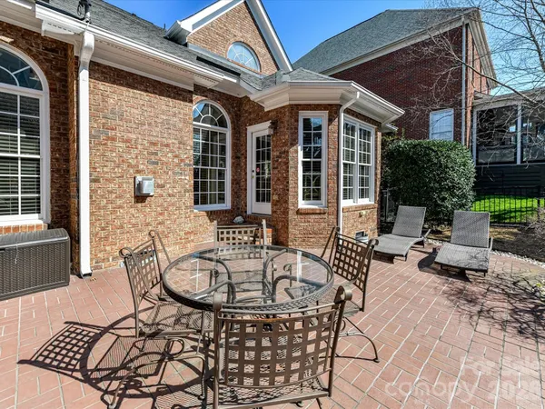 a view of a patio with table and chairs and potted plants
