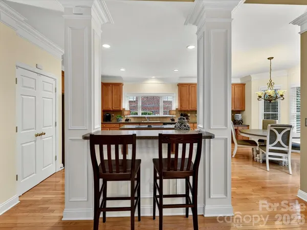 a dining room with furniture and wooden floor