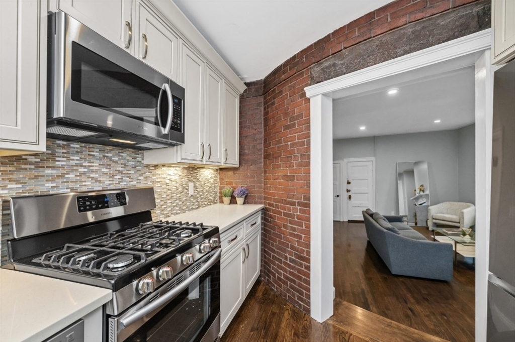 1880 Beacon Street, Unit 6 Brookline, MA 02445 - Photo 10 of 18 a kitchen with a stove and a microwave