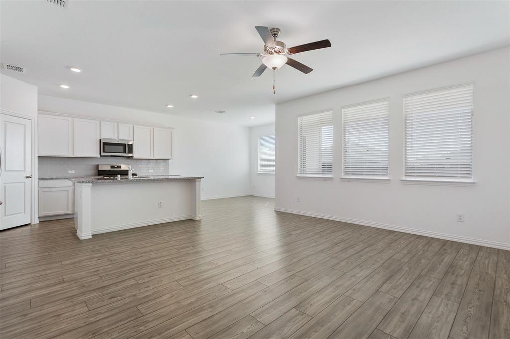 2157 Clarion Drive Forney, TX 75126 - Photo 11 of 28 a view of kitchen with granite countertop cabinets and wooden floor