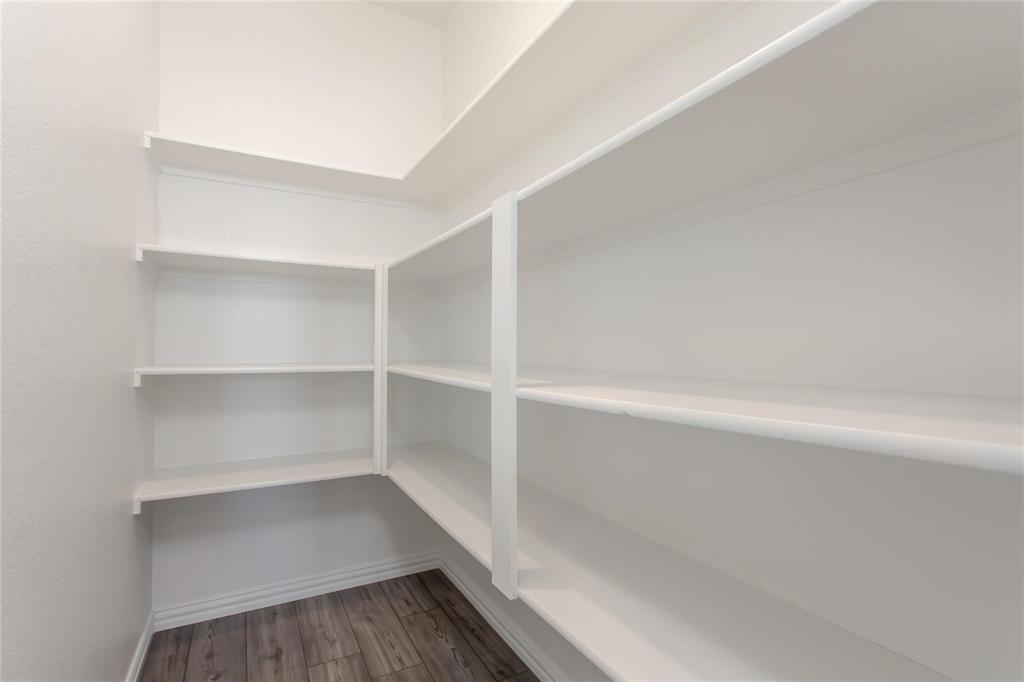2157 Clarion Drive Forney, TX 75126 - Photo 16 of 28 a view of walk in closet with empty racks