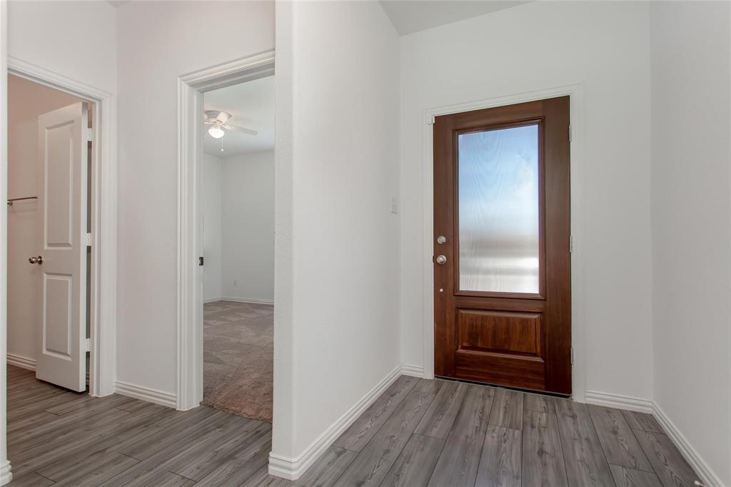 2157 Clarion Drive Forney, TX 75126 - Photo 2 of 28 a view of a hallway with wooden floor
