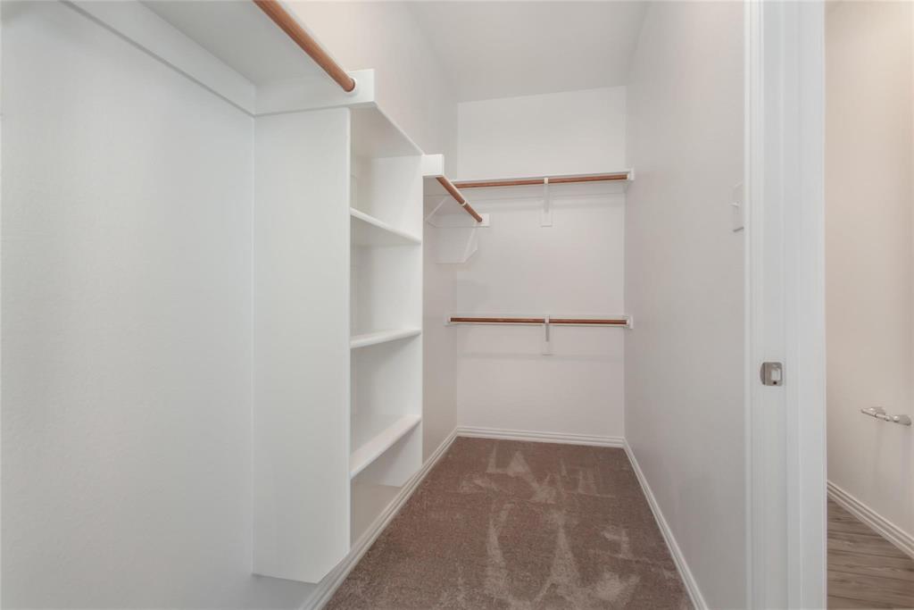 2157 Clarion Drive Forney, TX 75126 - Photo 25 of 28 a view of walk in closet with empty racks