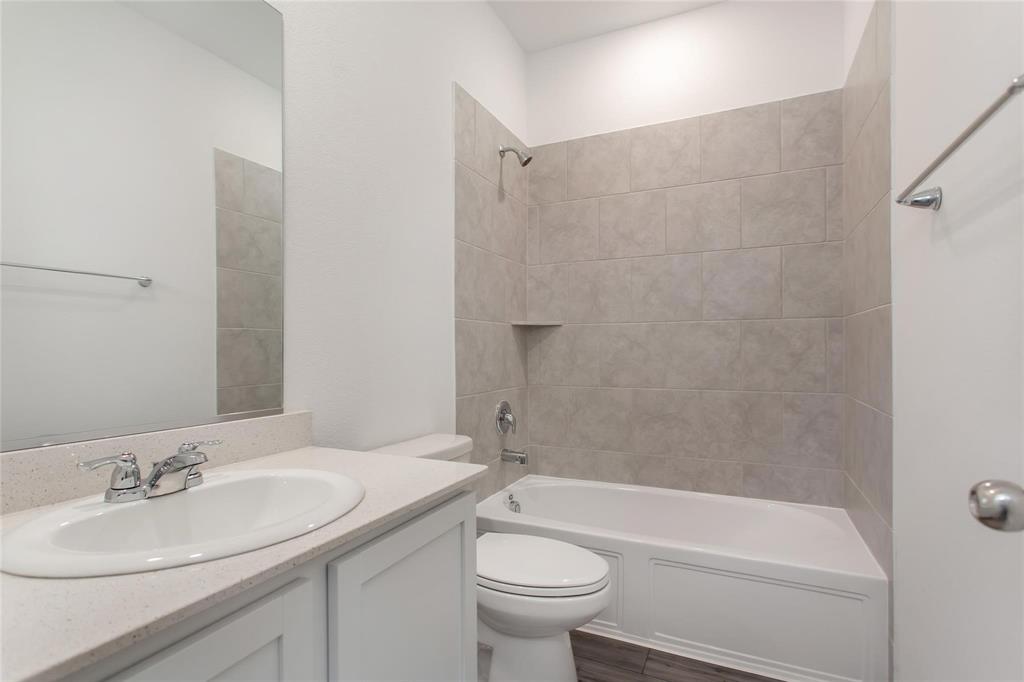 2157 Clarion Drive Forney, TX 75126 - Photo 3 of 28 a bathroom with a sink a toilet and a bathtub