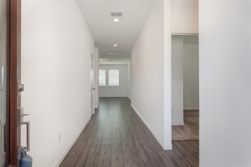 2157 Clarion Drive Forney, TX 75126 - Photo 4 of 28 a view of a hallway with wooden floor