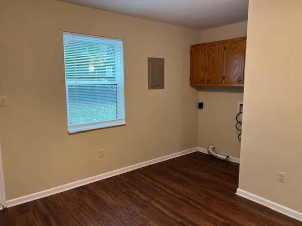 a room with a wooden floor and a window