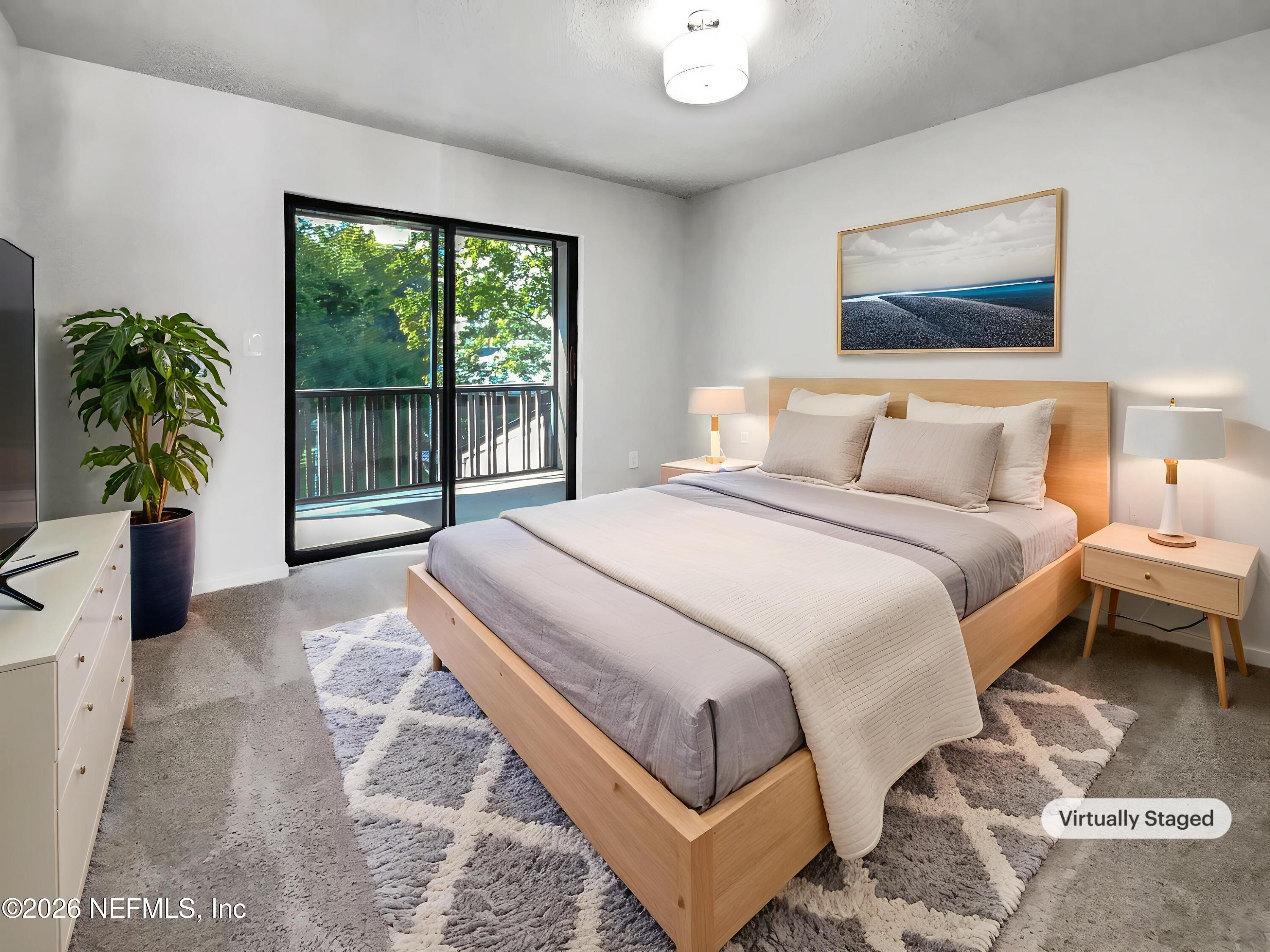 7208 Cypress Cove Road, Unit 13 Jacksonville, FL 32244 - Photo 11 of 22 a bedroom with a bed and a large window